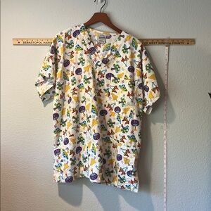 Men’s XL scrub top with bright mushroom pattern.